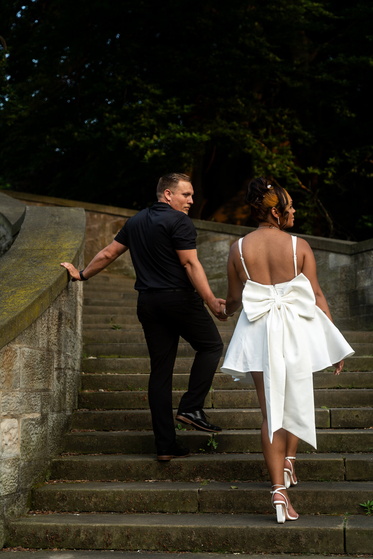 Couple walking hand in hand during golden hour engagement session in Cleveland, Ohio