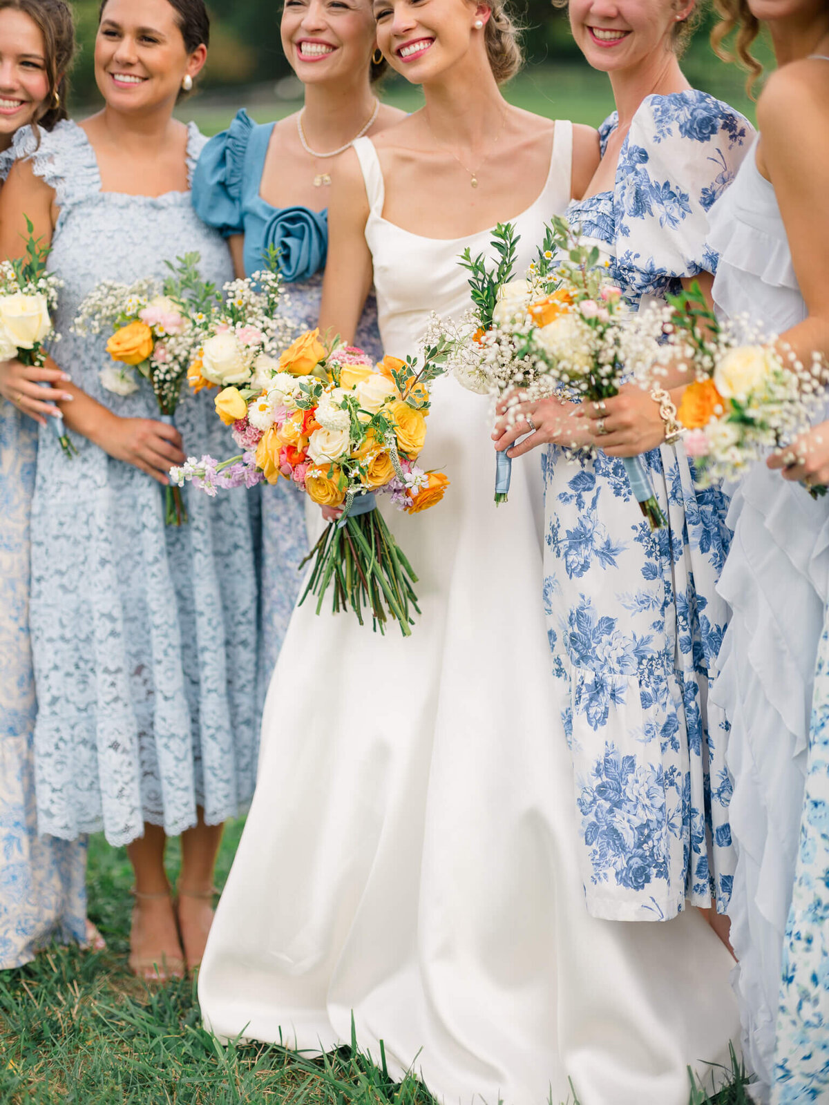 Bride and bridemaids holding bouquets during bridal party portraits. Captured by Washington DC Wedding Photographer Bethany Aubre Photography.