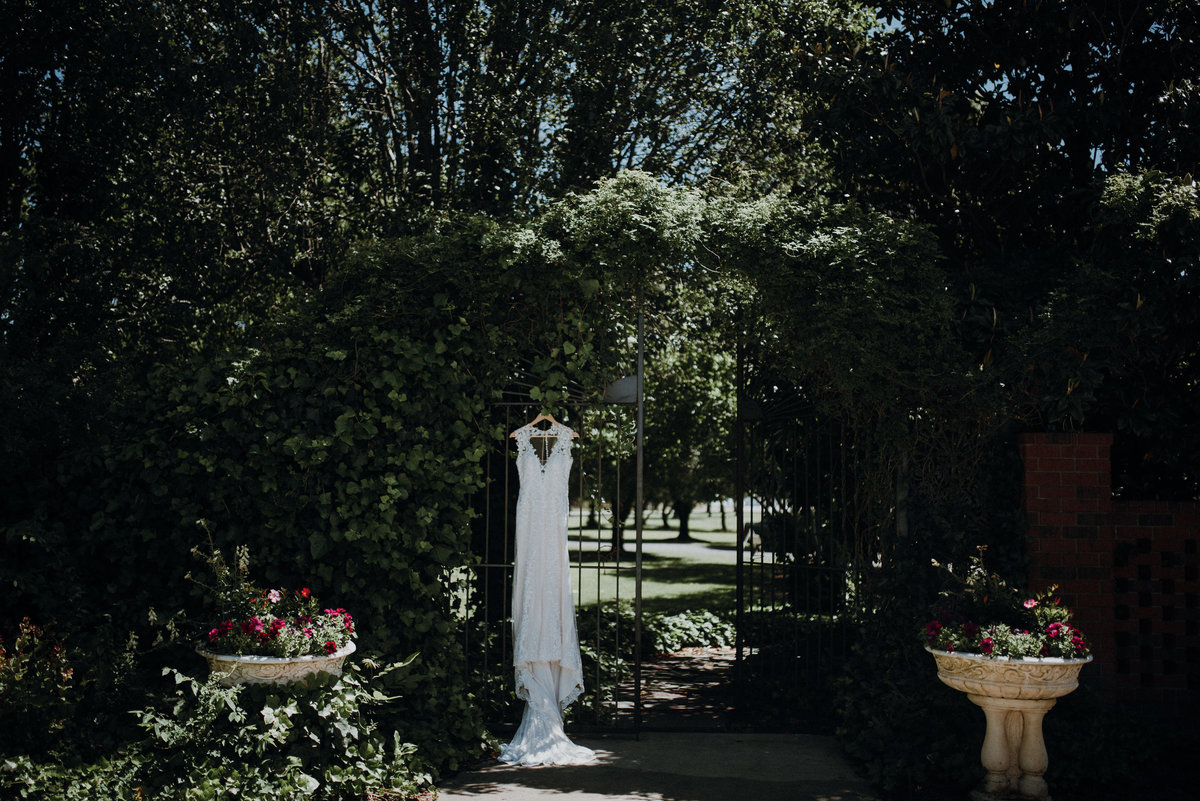 Dress hanging on the gate at the beautiful Adams Estate Wedding in Arkansas