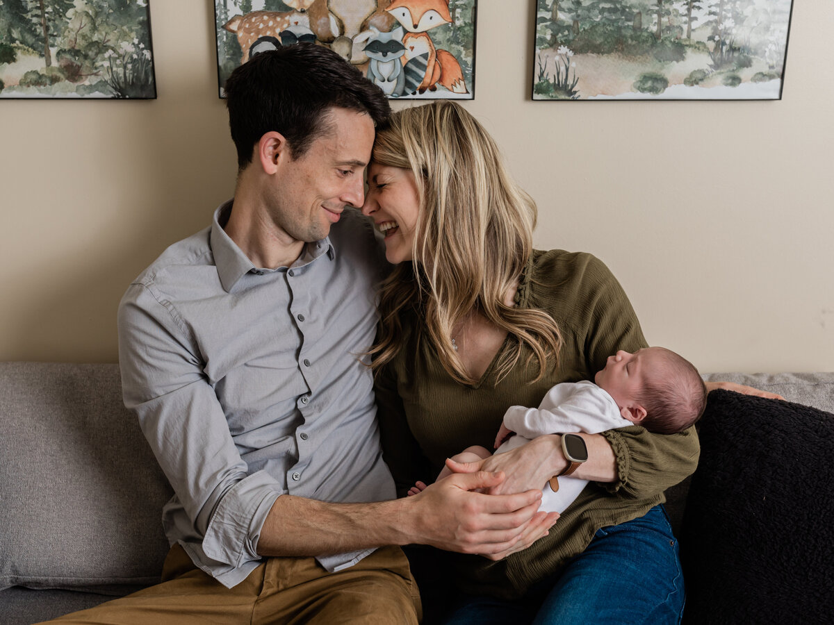 mom and dad holding newborn baby boy for in home photoshoot cleveland newborn photographer