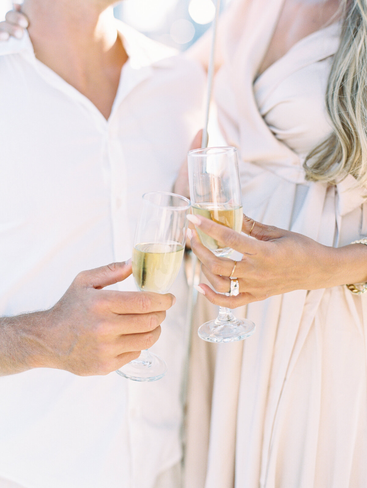 Bride and groom holding champagne flutes on a silboat in Chicago photographed by Arielle Peters Photography