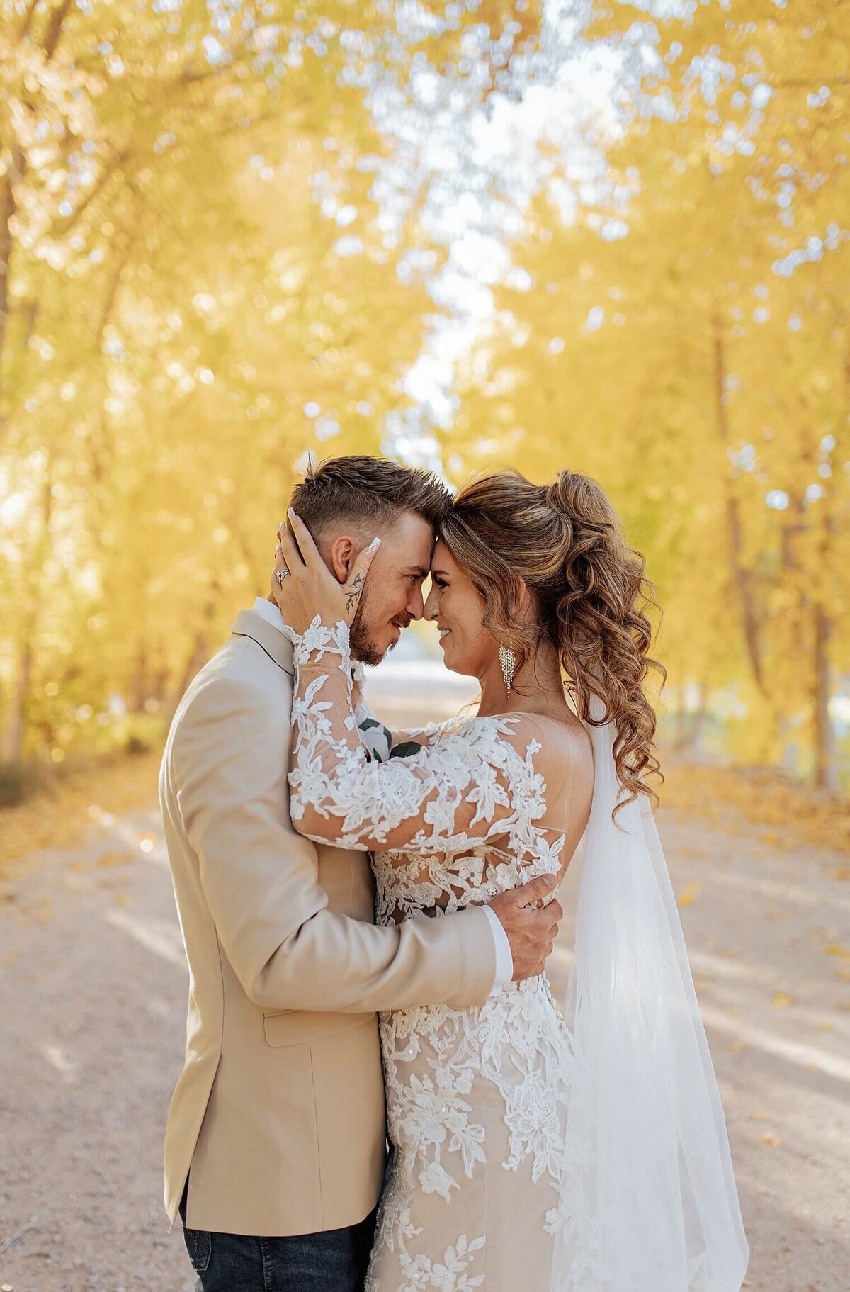 Bride and groom portrait with brides hands holding her grooms head