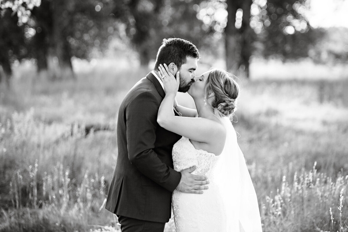 black-and-white-bride-and-groom-kiss-platte-river-fort-greeley-colorado