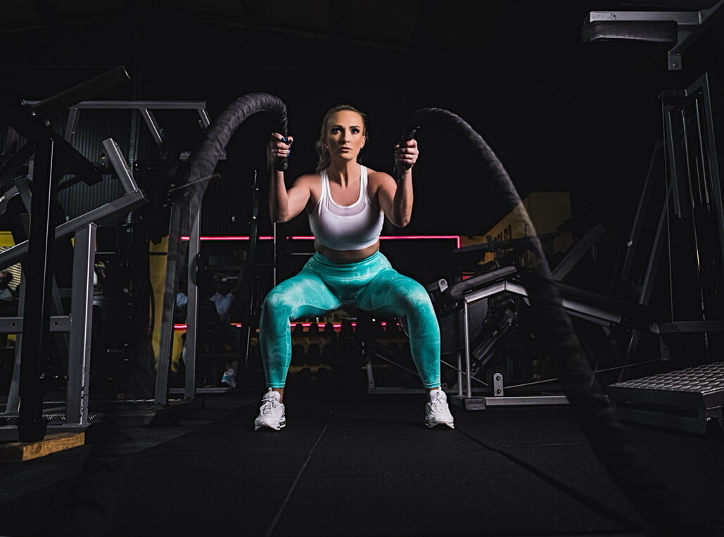 Woman in blue gym leggings with ropes