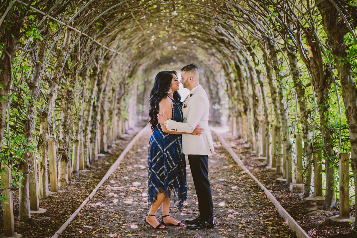A couple sharing a moment inside the tree allee tunnel in snug harbor garden in staten island ny