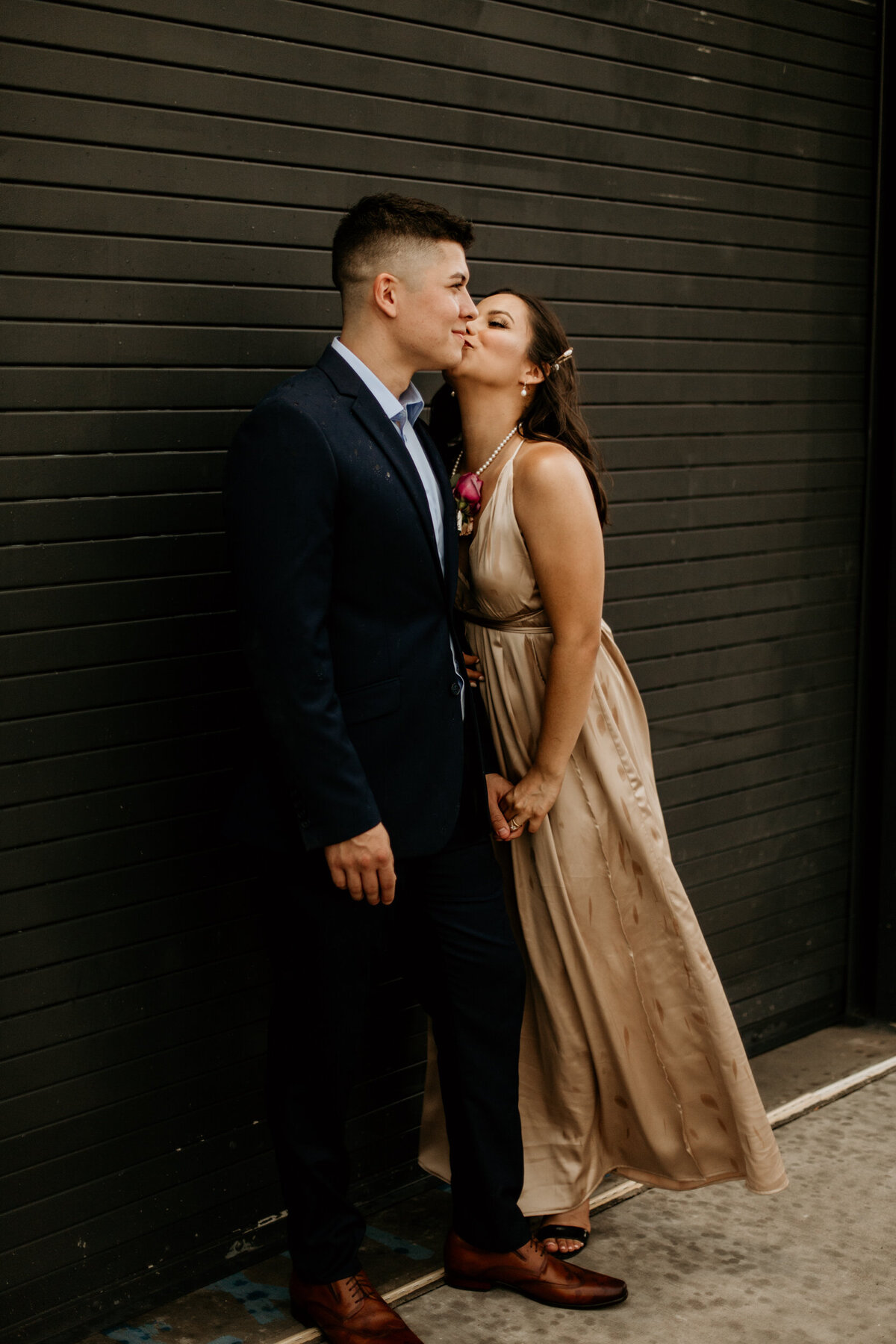 bride and groom standing in front of a black door in downtown Albuquerque