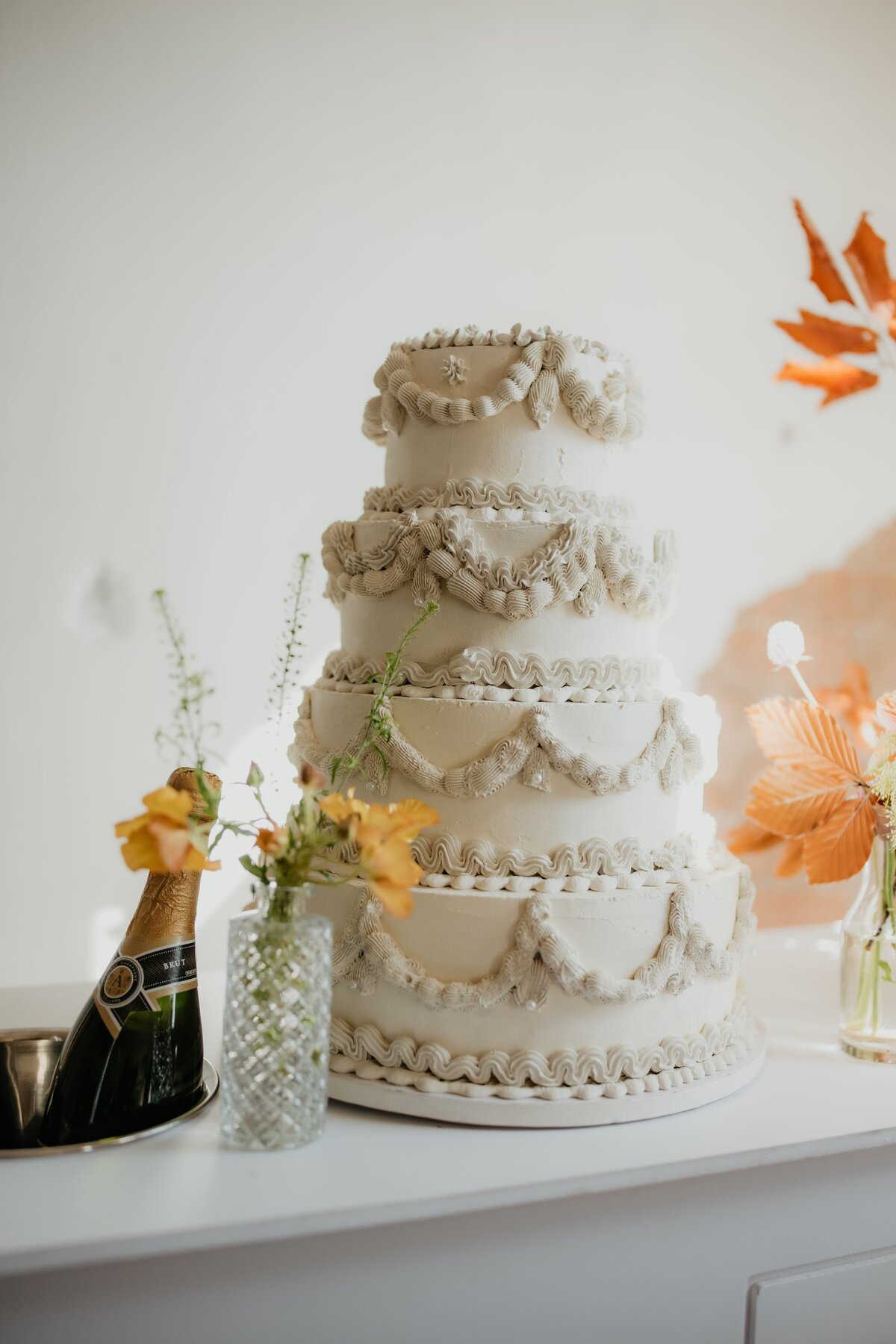 big wedding cake on table with floral decor, canyon texas weddings