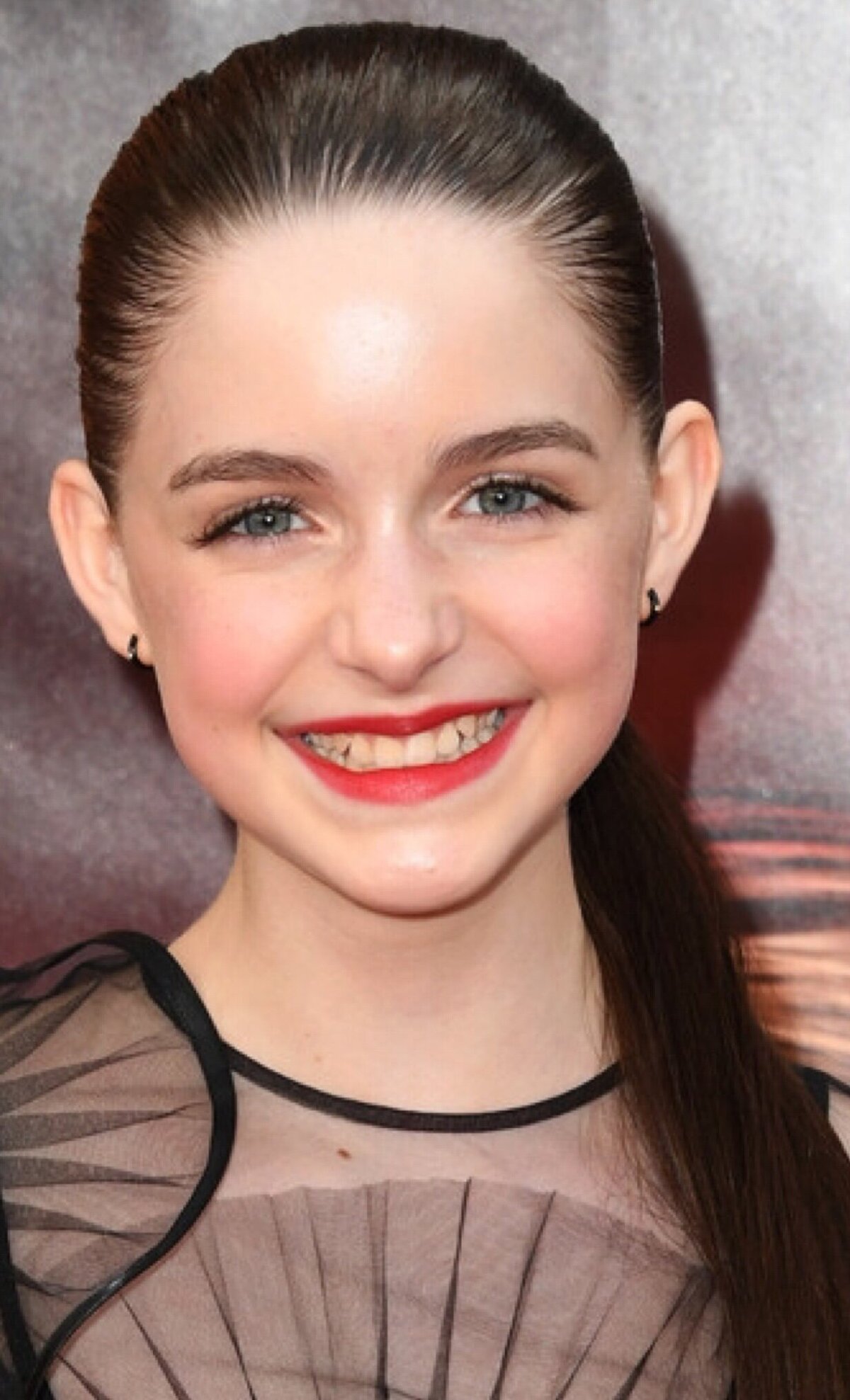 McKenna Grace in a black dress and red lipstick