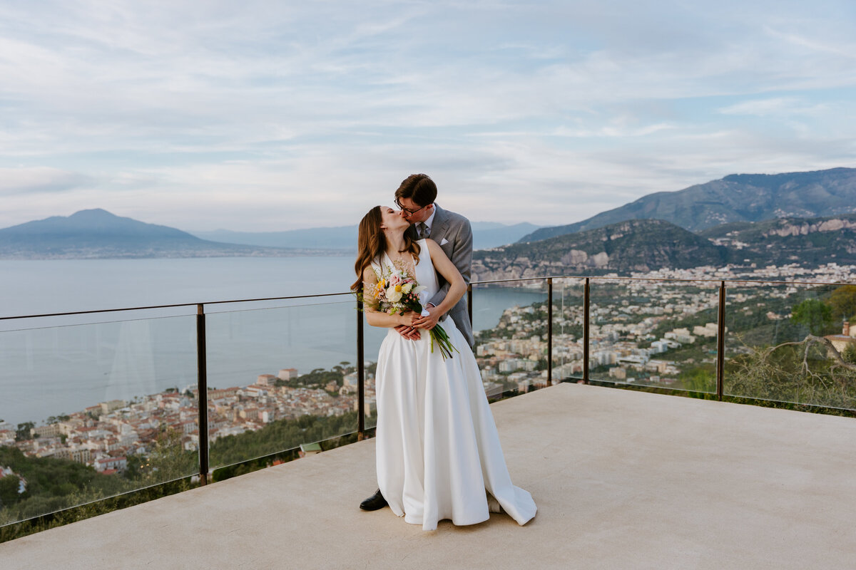 Couple hugging on Sorrento terrace at sunset