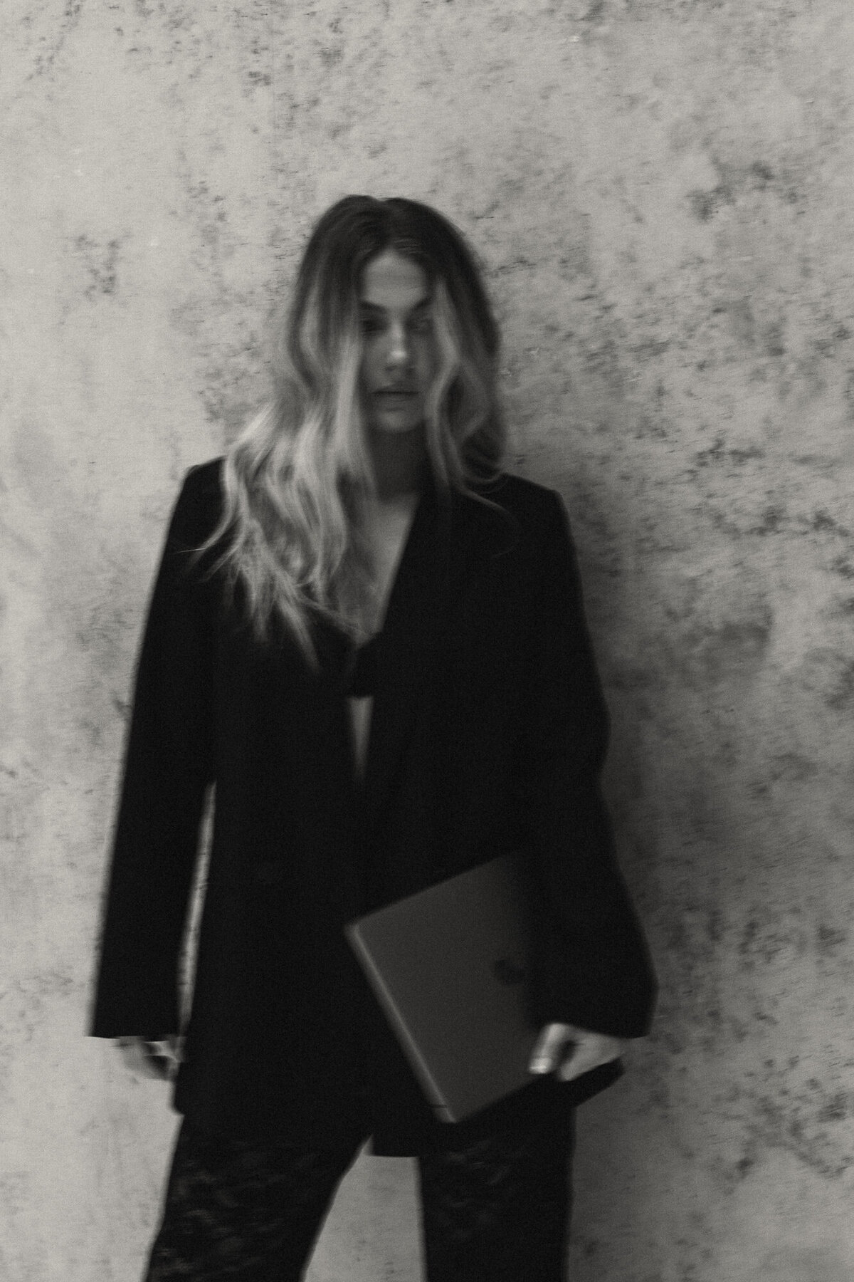 Cinematic branding portrait of a mindset coach, captured with rich, moody lighting for an empowering brand presence.