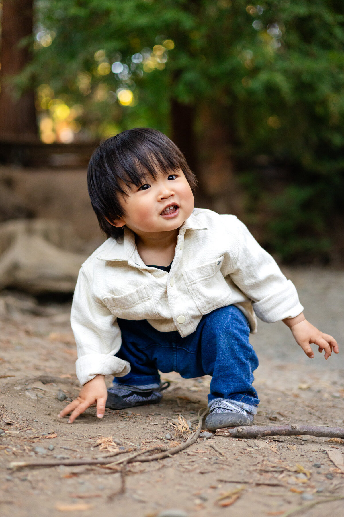 Toddler crouching and smiling outdoors in forest setting – Bay Area Family Portfolio | Ellobelle Photography