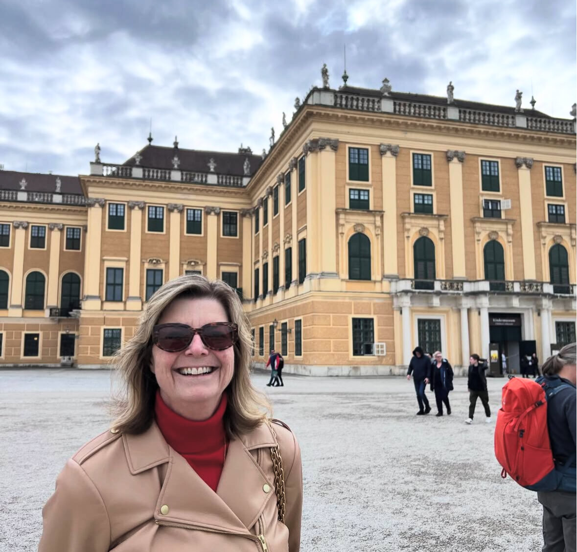 Kelly smiling next to European Building