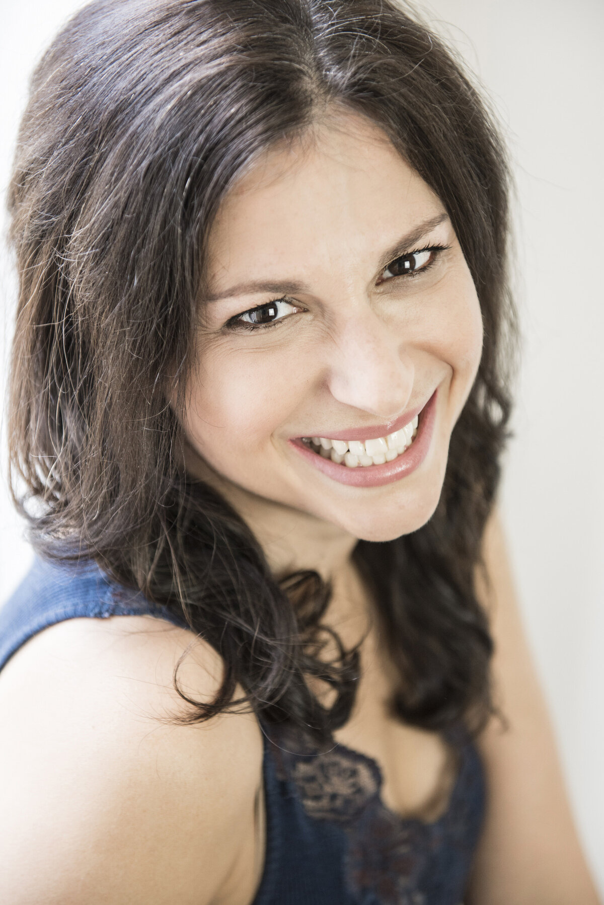 A woman smiling and looking off to the side