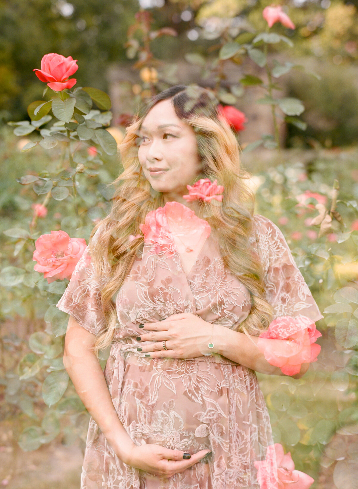 Double exposure of expectant mom in front of rose bushes. Image by Raleigh maternity photographer A.J. Dunlap Photography.
