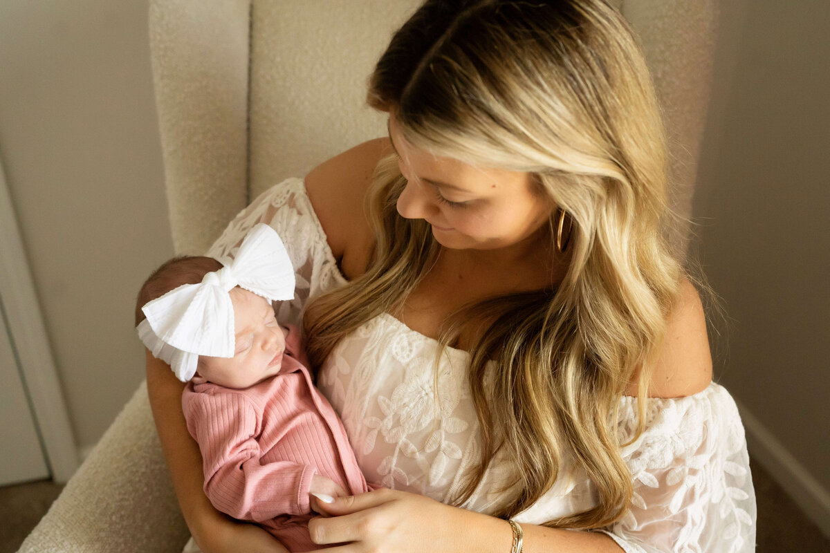 Mother holding newborn girl in her arms