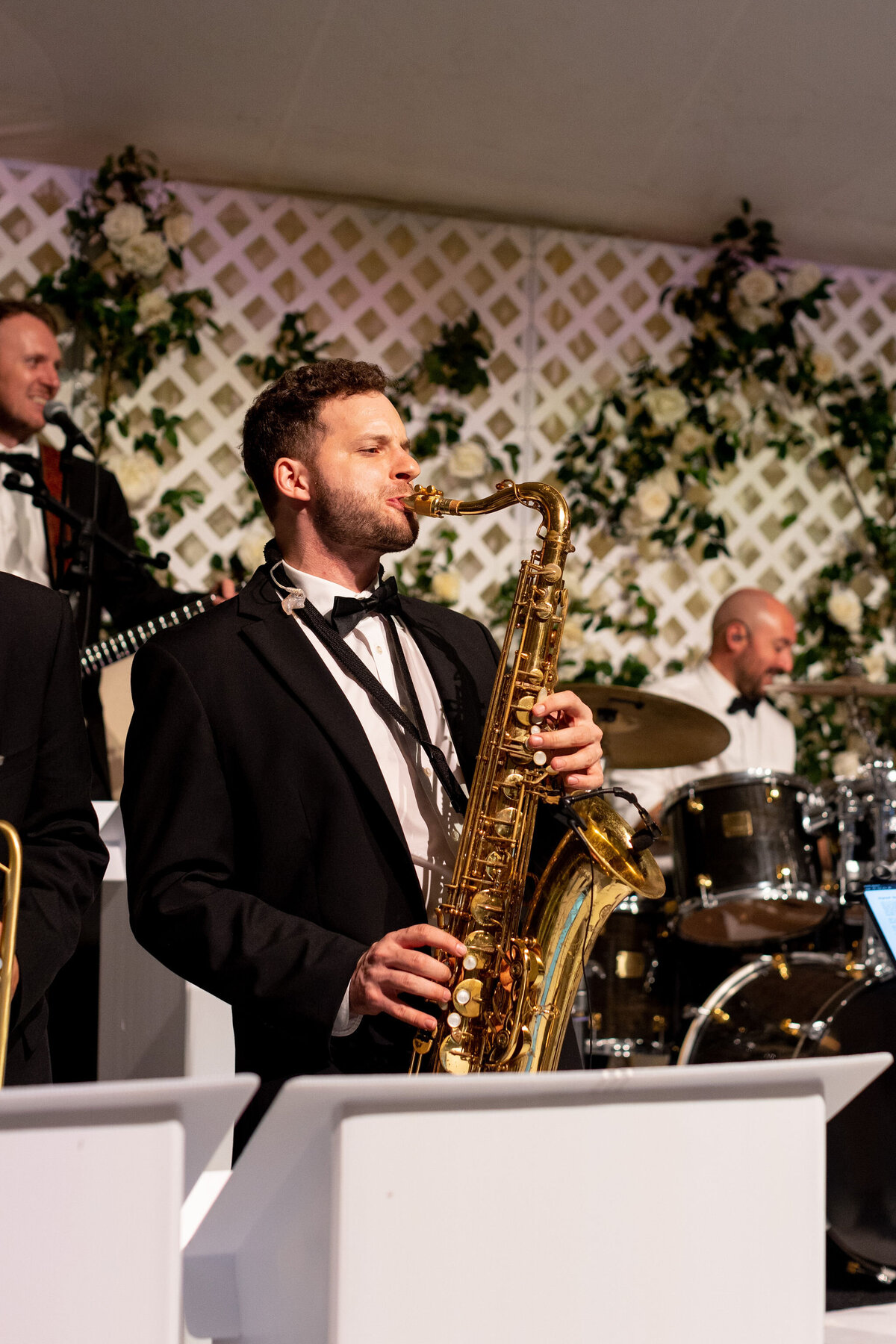 A photo of a band member playing the saxophone a the wedding.