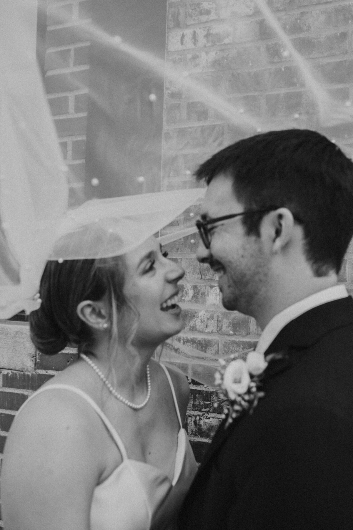 Bride and groom share a kiss, classic wedding photography in Indiana.