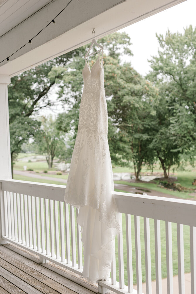 wedding gown hanging on a front porch