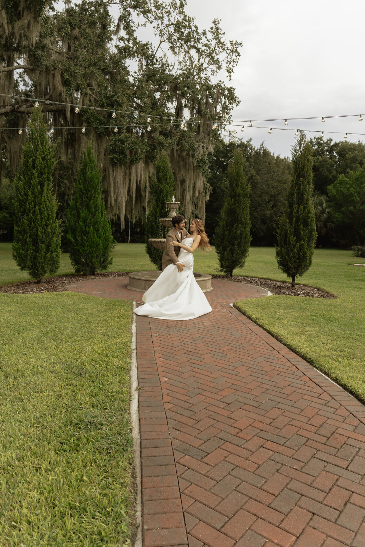 Romantic backyard wedding at The Palm Mansion in Umatilla, Florida with lush palm trees and floral arch