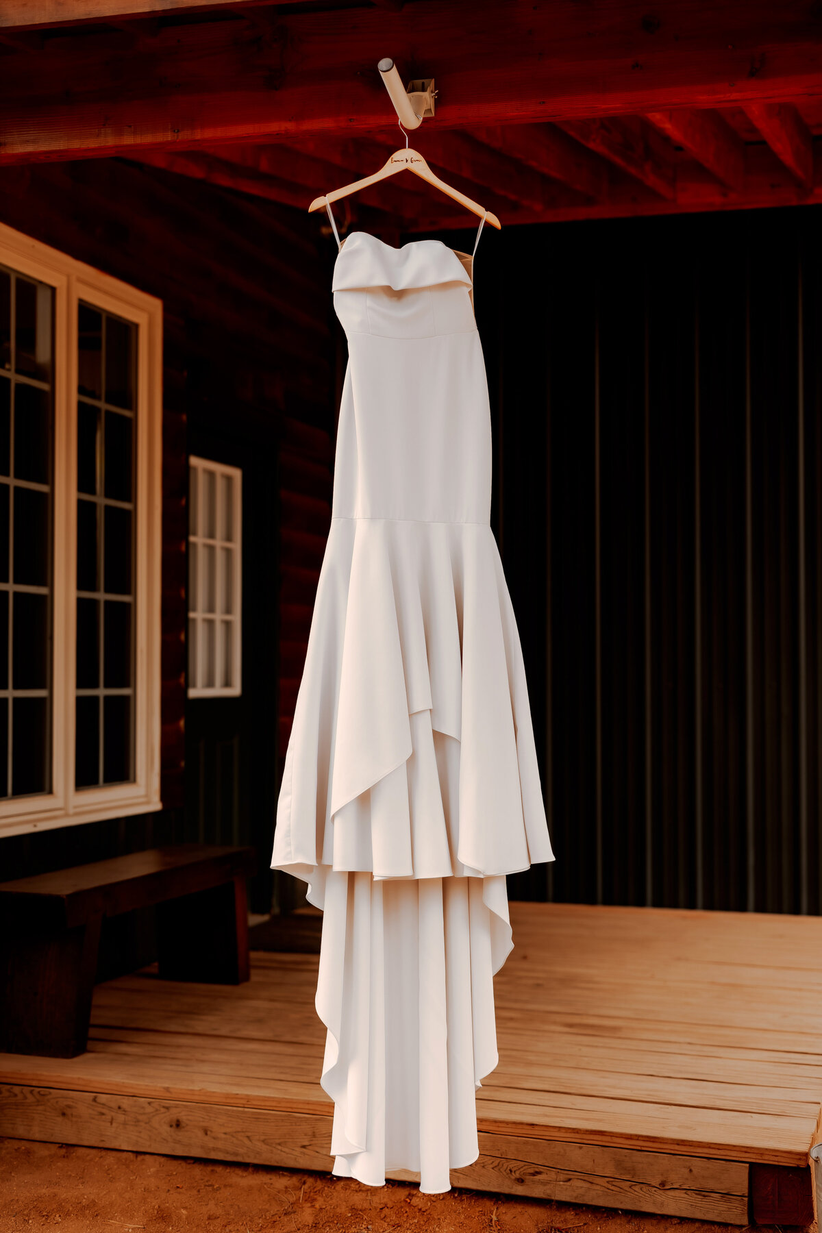 Bride's dress hanging outside of cottage in Pine, Colorado