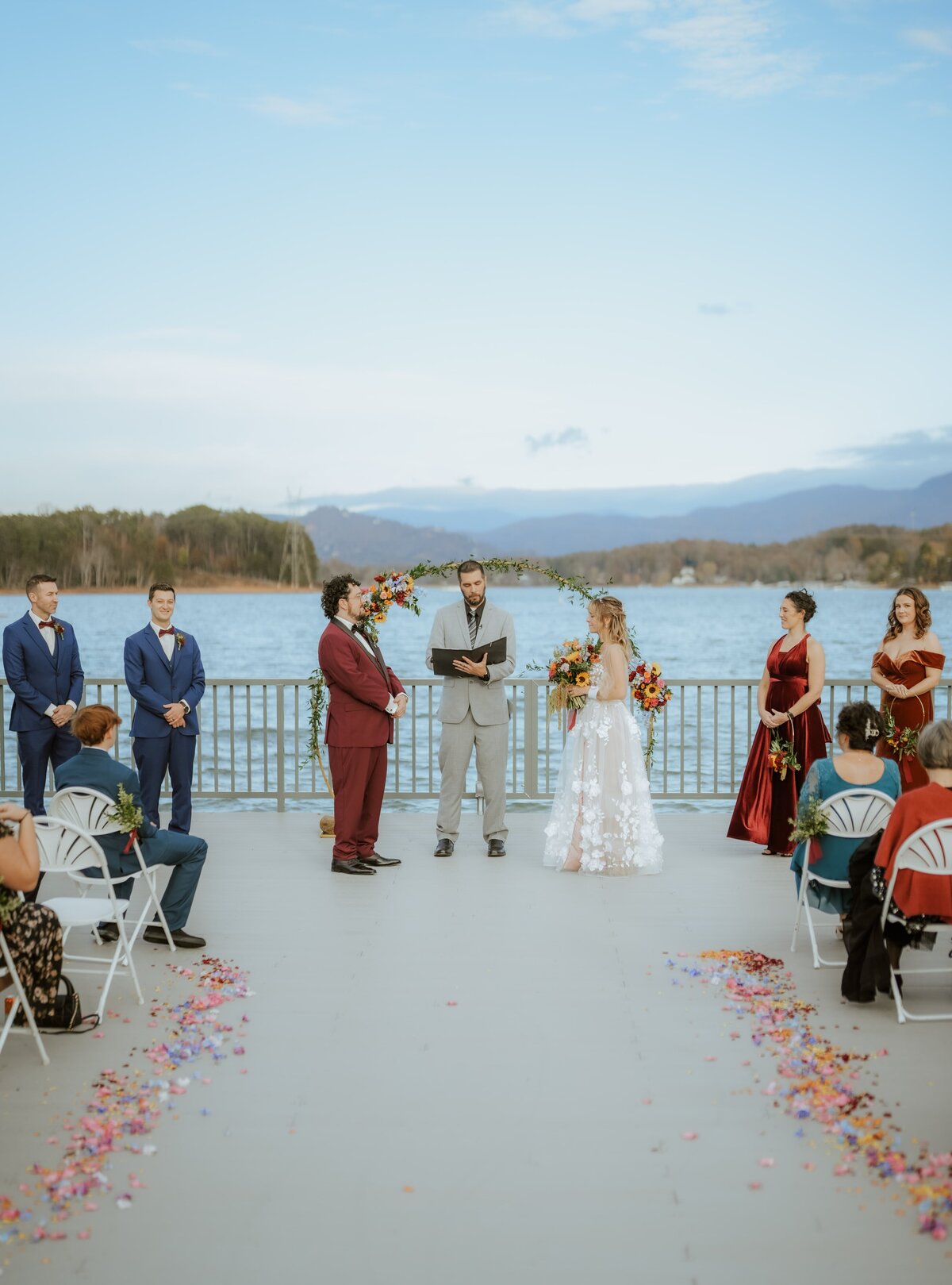 Bride and groom getting married on the lake with their friends