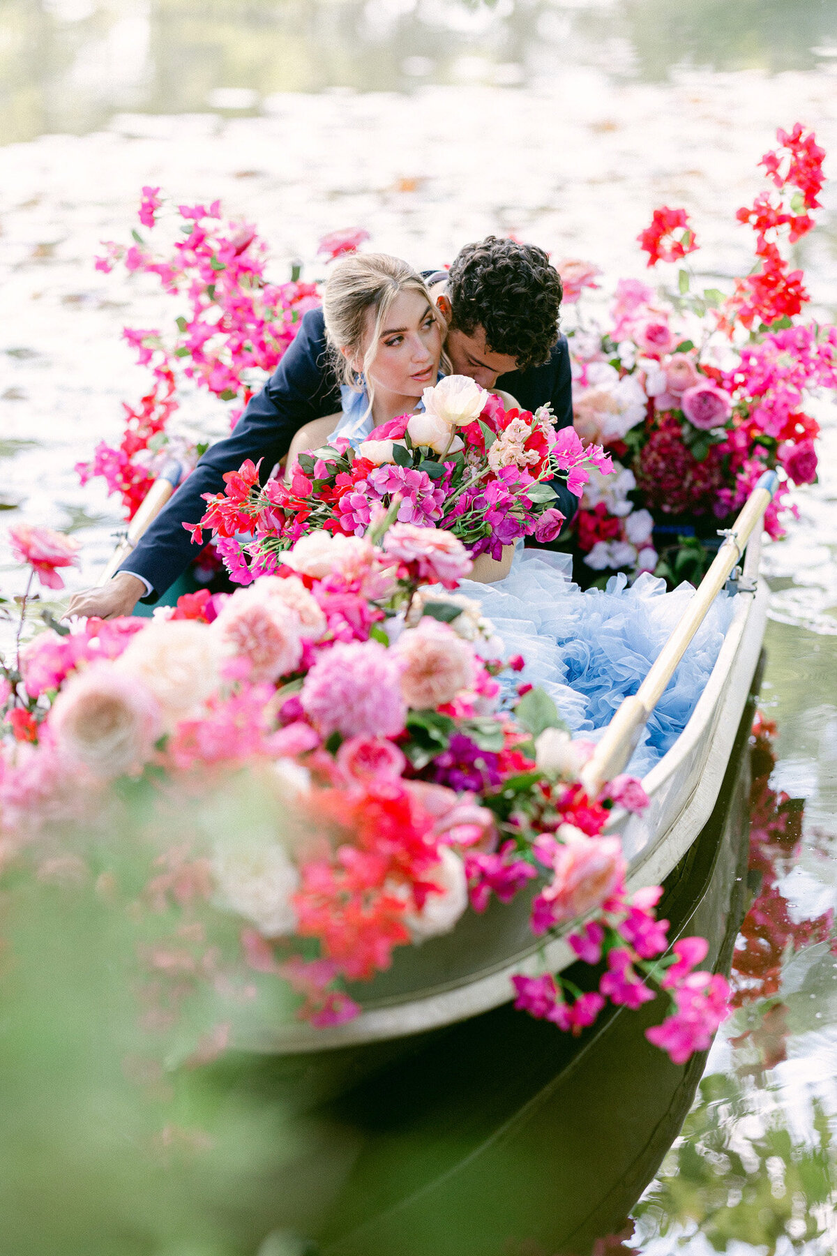Couple on a boat sailing the lake with colorful florals