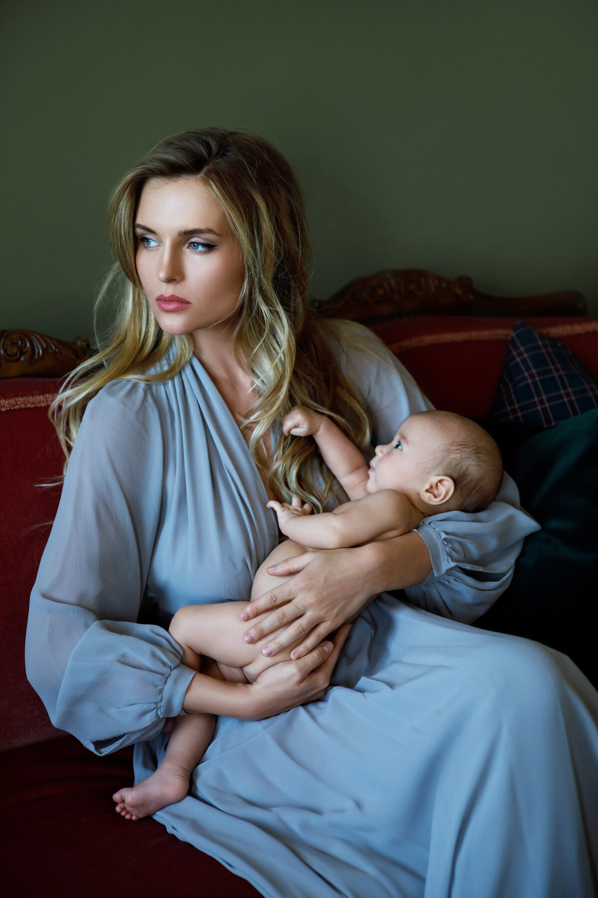 portrait-young-beautiful-mother-wearing-luxury-grey-dress-holding-her-baby-hands