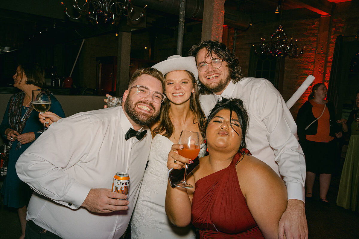 Wedding guests posing for fun reception flash portrait in high-end downtown San Antonio venue