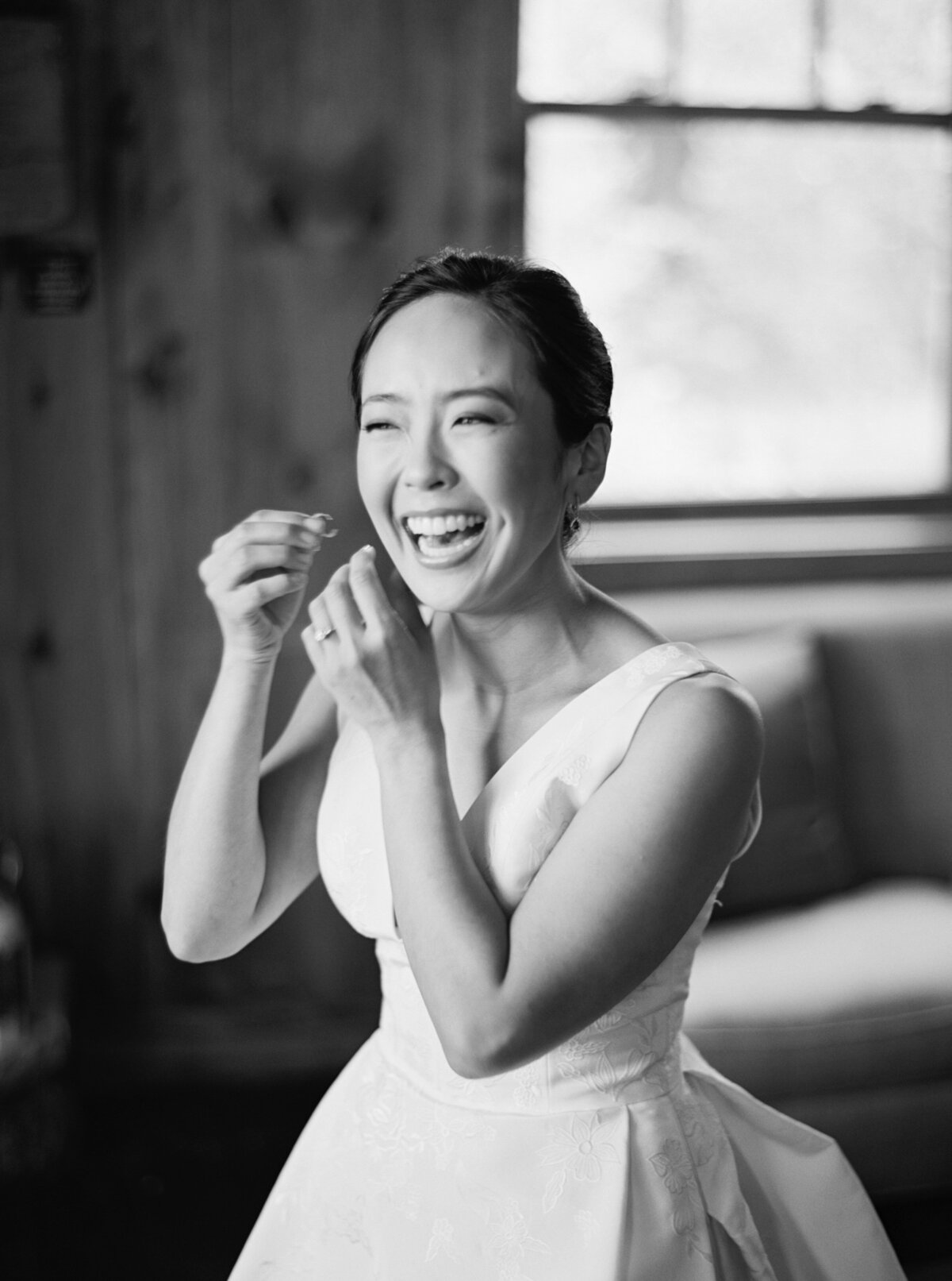 Bride laughing and getting ready at Brush Creek Ranch wedding