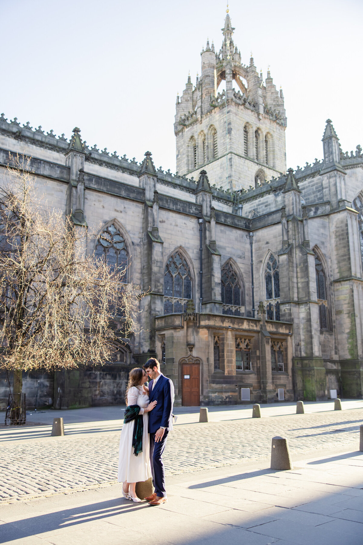 brie and groom hug in front of cathedral.jpg