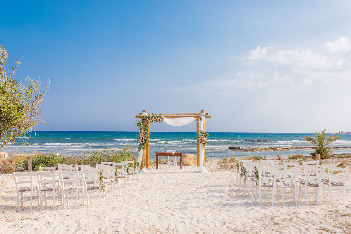 A rustic and natural beach setting with wooden arch