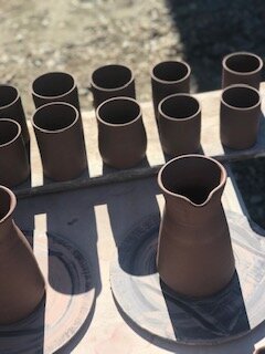 raw clay cups in sun