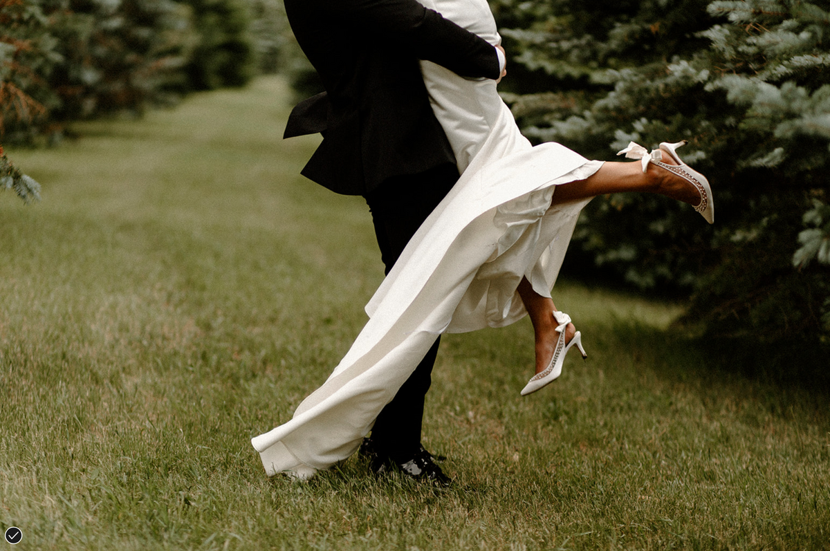 a groom lifting his bride off the ground