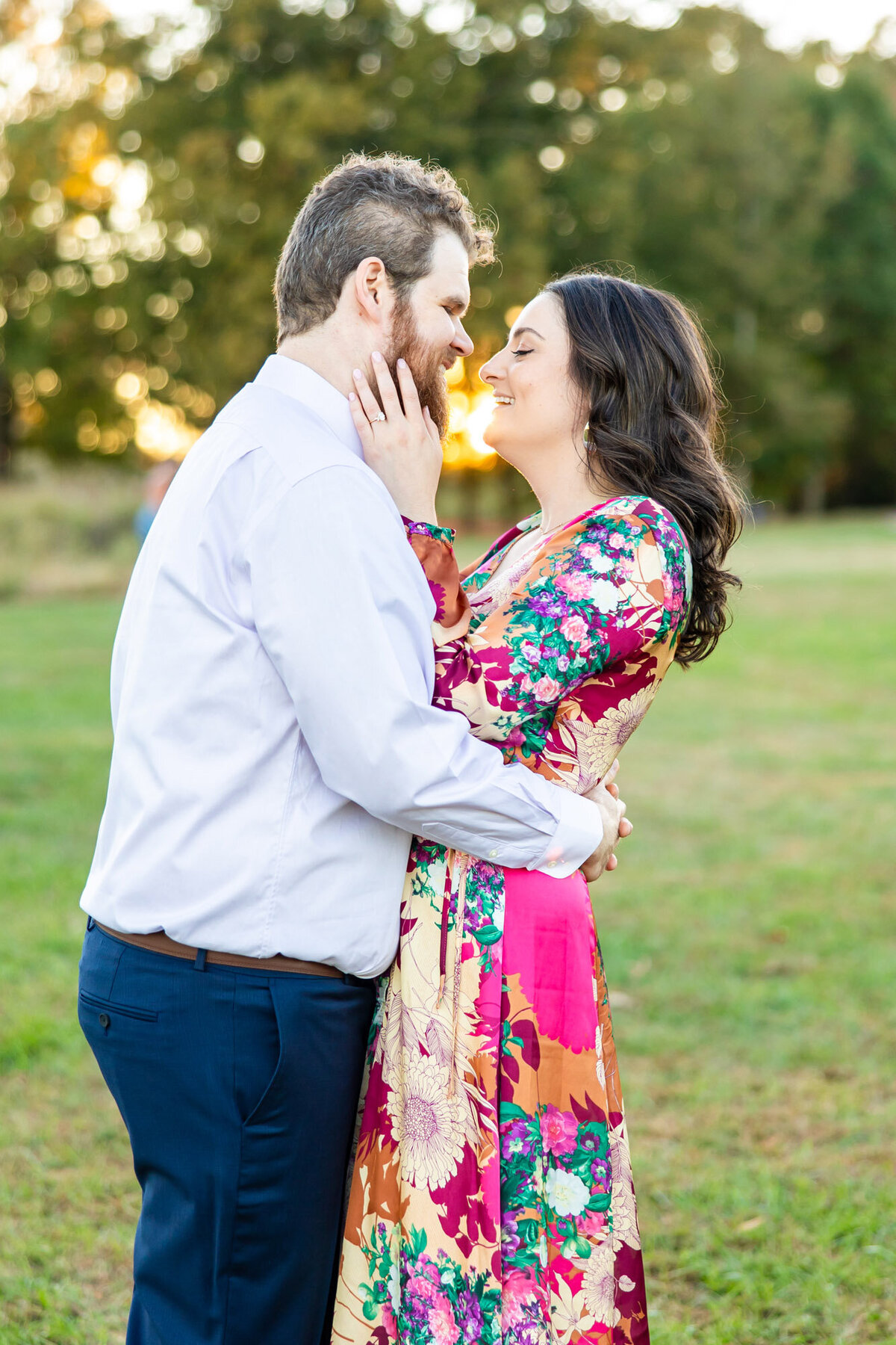 Newly engaged couple embracing each other outside