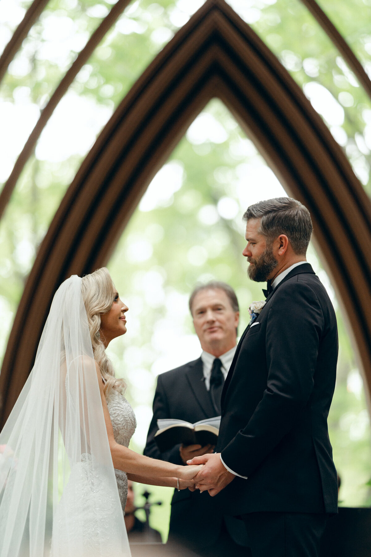 A wedding photo of the bride and groom on the alter at Anthony's Chapel in Hot Springs Arkansas