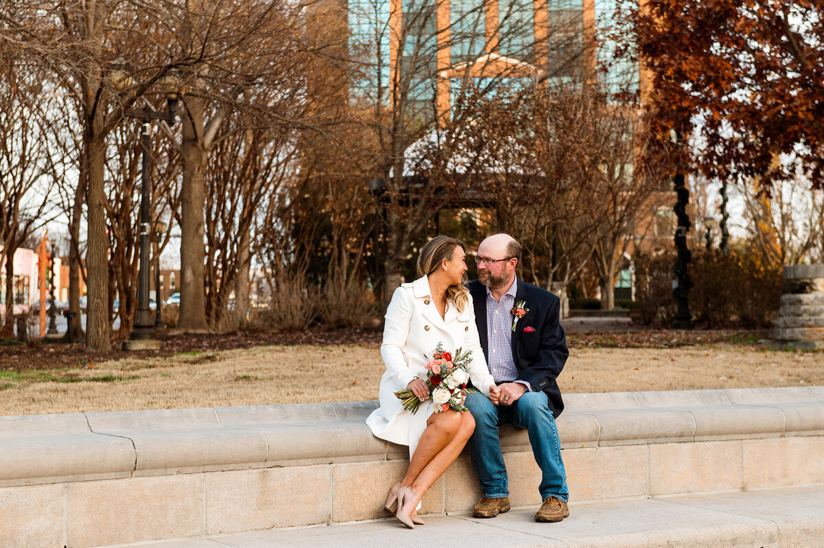 Couple sitting together during fall elopement