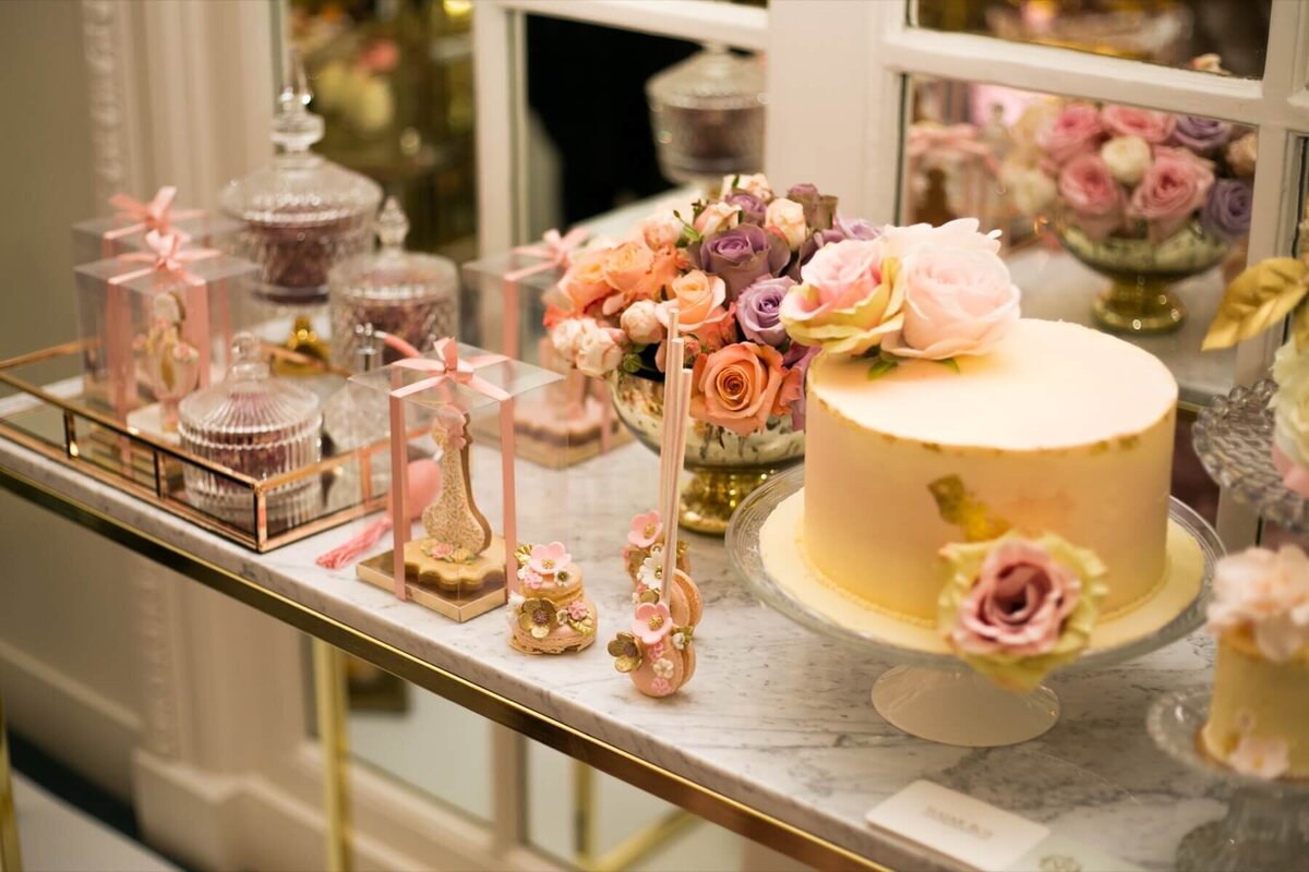 Opulent cake table with wedding cake and sweets