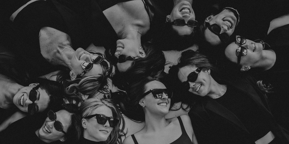 Black and white picture of women smiling together in a circle