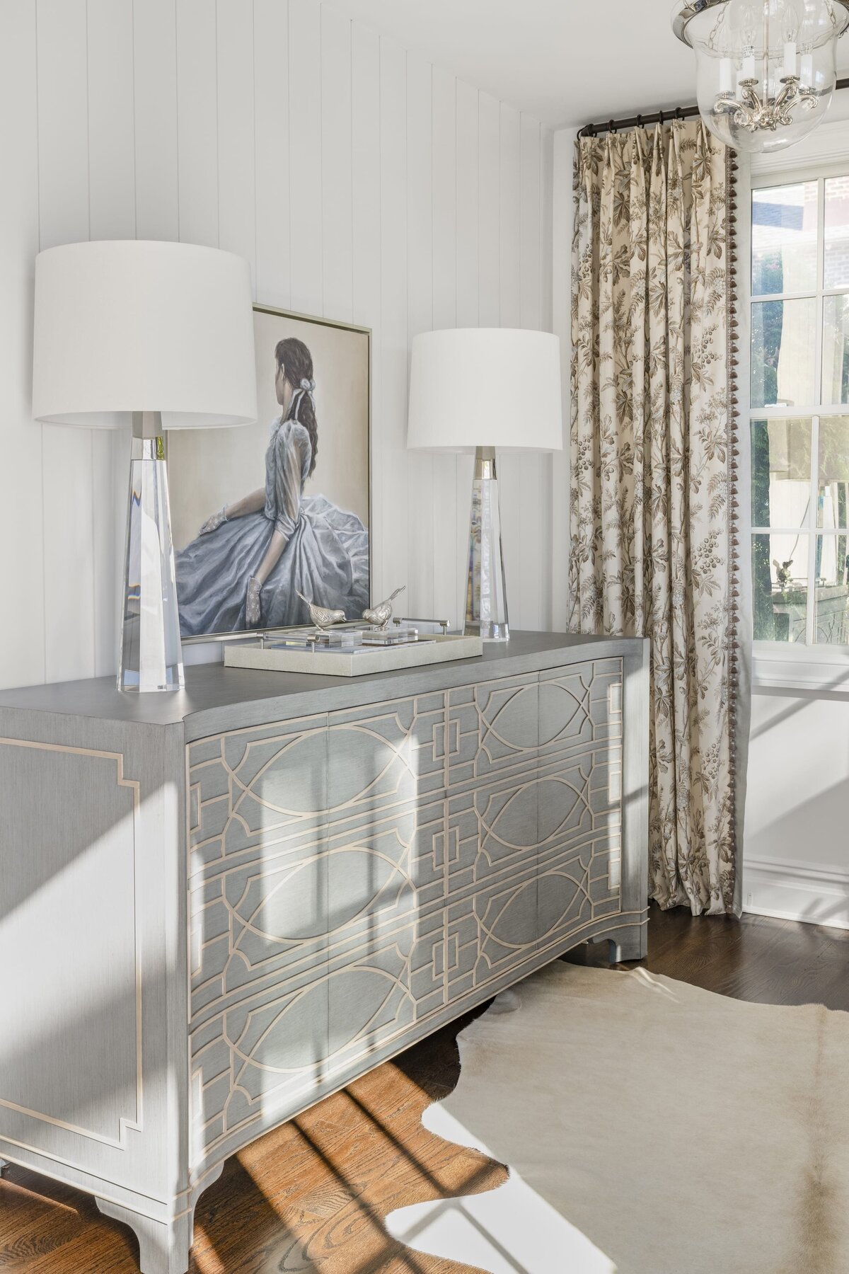 candra lynn interiors ocean port project large blue cabinet with glass lamps and picture frame