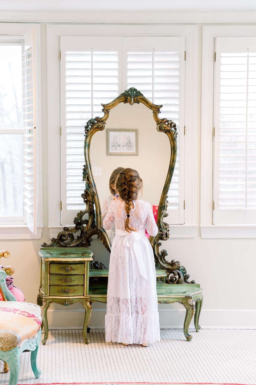 Flower girl looking at her reflection in the mirror