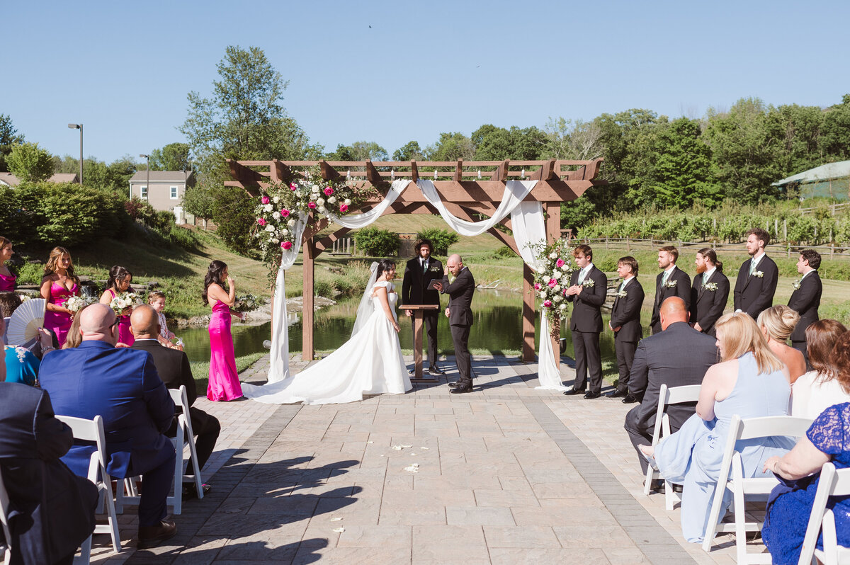 outdoor wedding ceremony with hot pink elegant theme at bear brook valley NJ photo