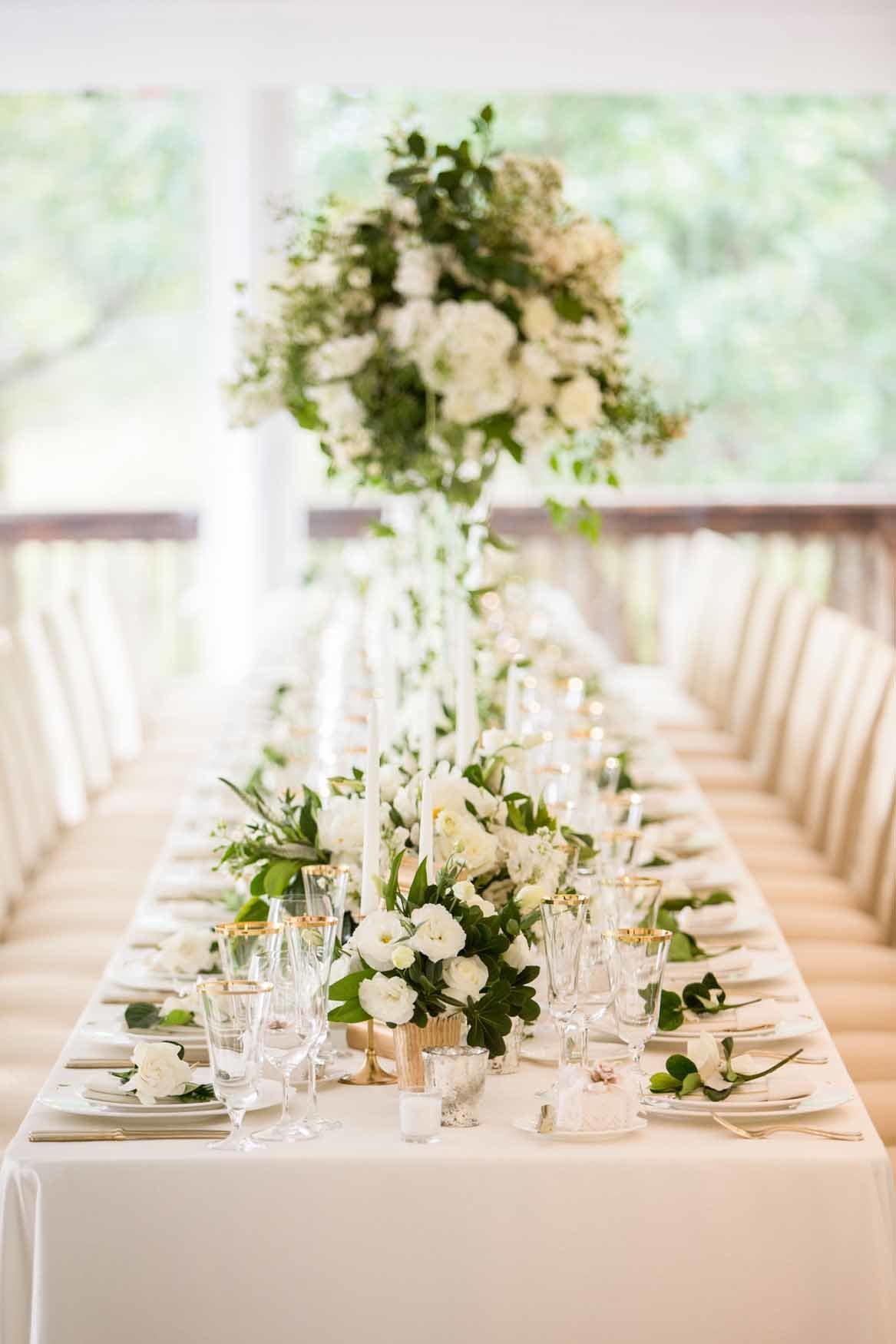 Luxe white tent wedding with white flowers