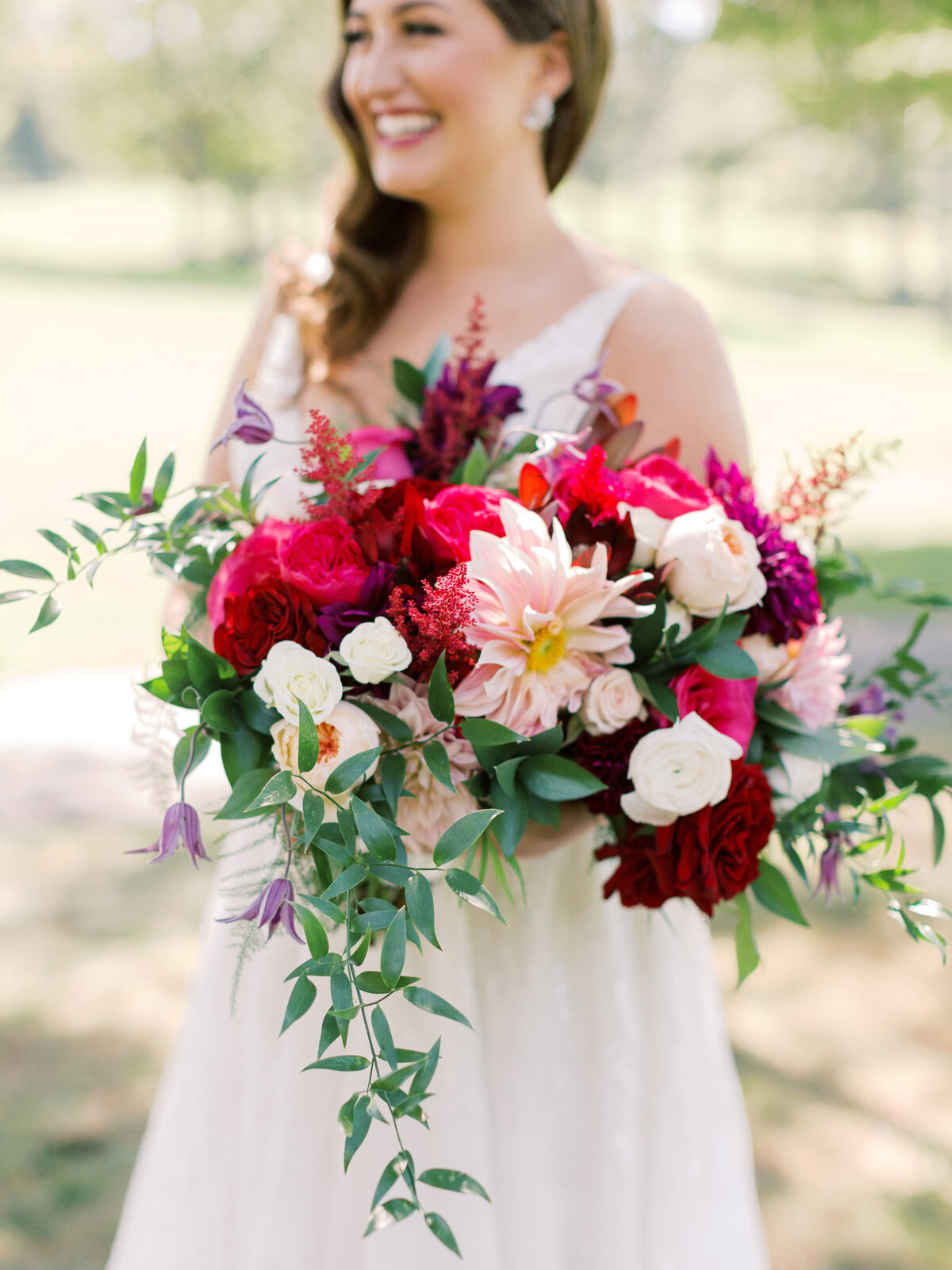 Hot pink, burgundy, pink and white large bridal bouquet with bride in Fairfax, VA