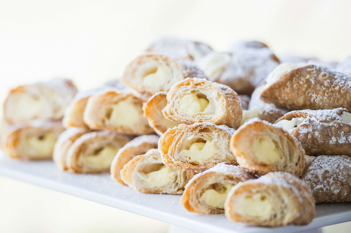 a closeup photo of cannoli being served at a corporate anniversary celebration. Captured by Ottawa Event Photographer JEMMAN Photography COMMERCIAL