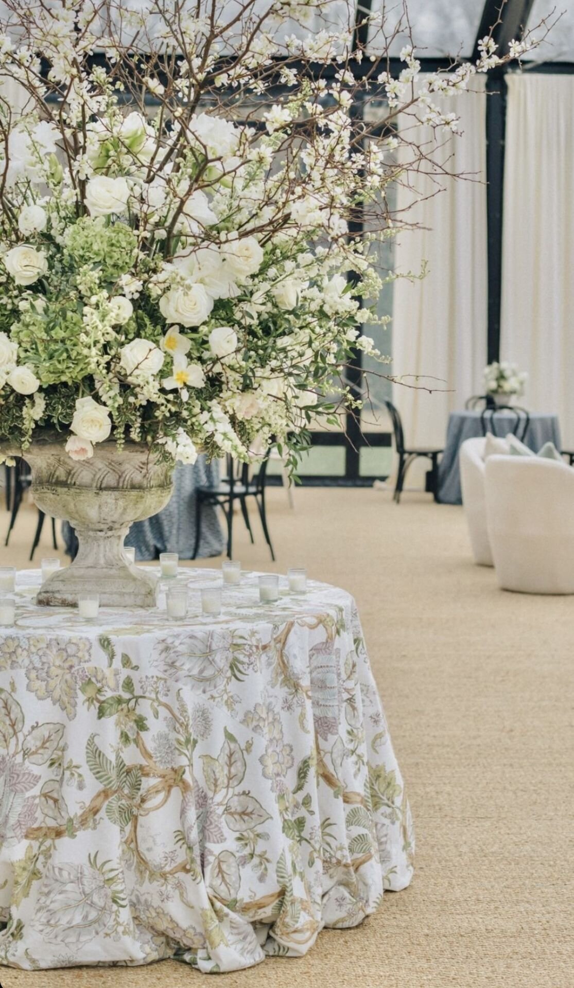 Floral installation on neutral linen cocktail table, editorial cocktail hour inspiration for Sycamore Bend Estate