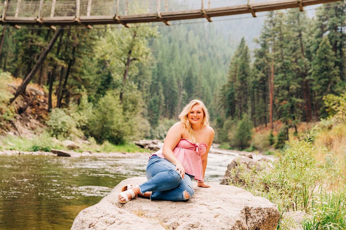 Senior photo of girl near suspension bridge at Rock Creek, Montana