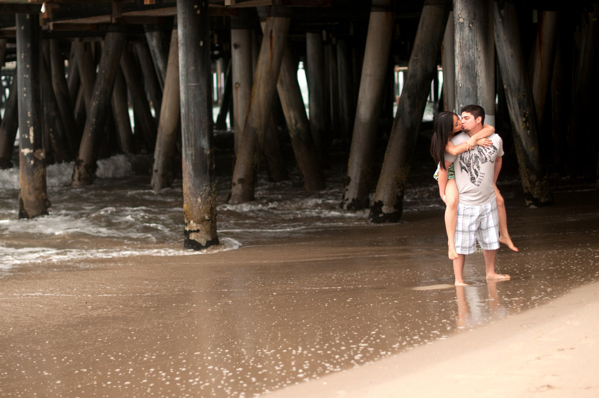 Santa Monica Pier engagement photographer for the fun couples. Santa Monica Pier engagement photo in West Los Angeles. Southern California state beach engagement photo. West Los Angeles Beach engagement photo.