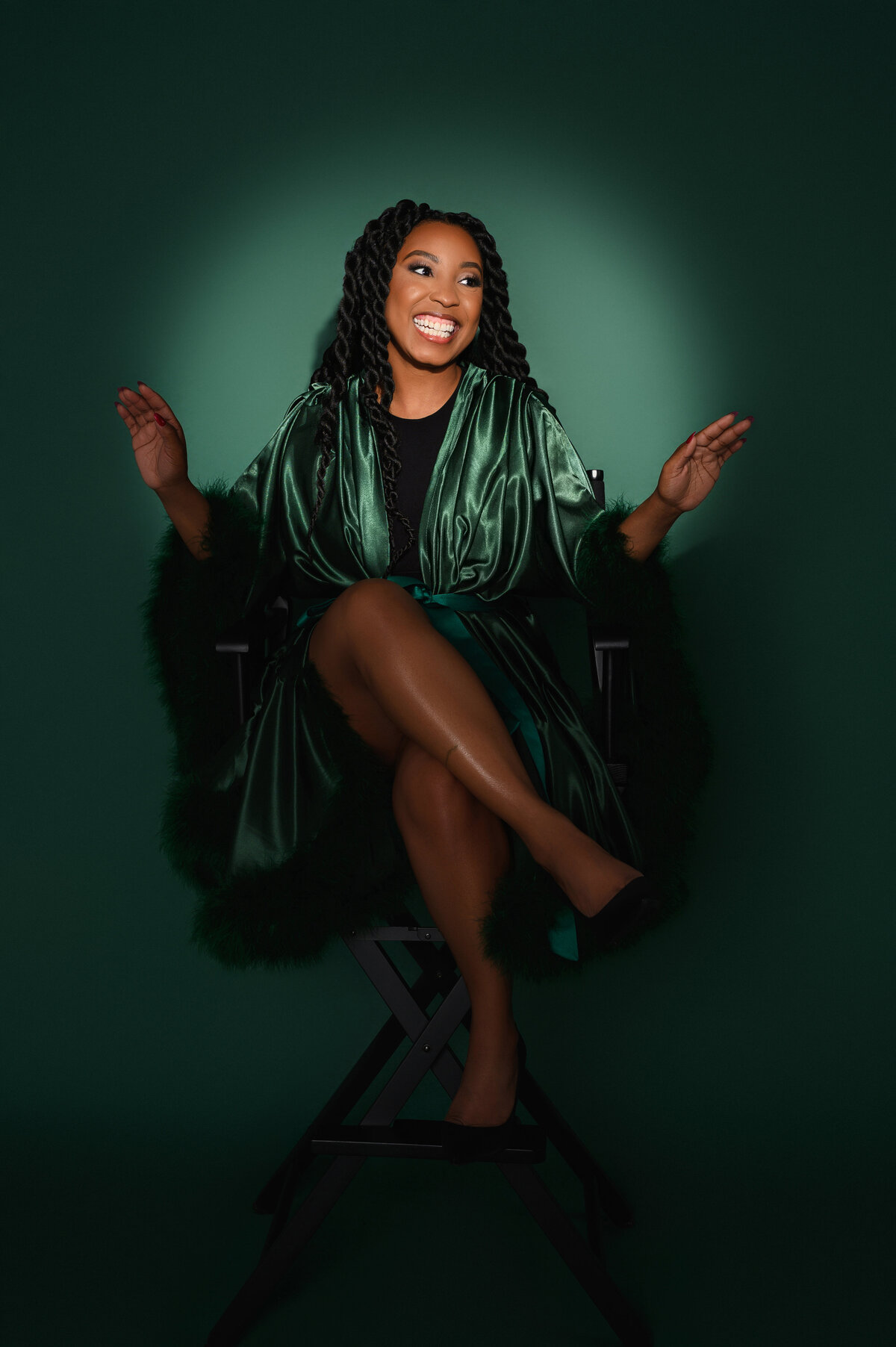 Radiant portrait of a woman in a luxurious green satin robe, exuding confidence and elegance