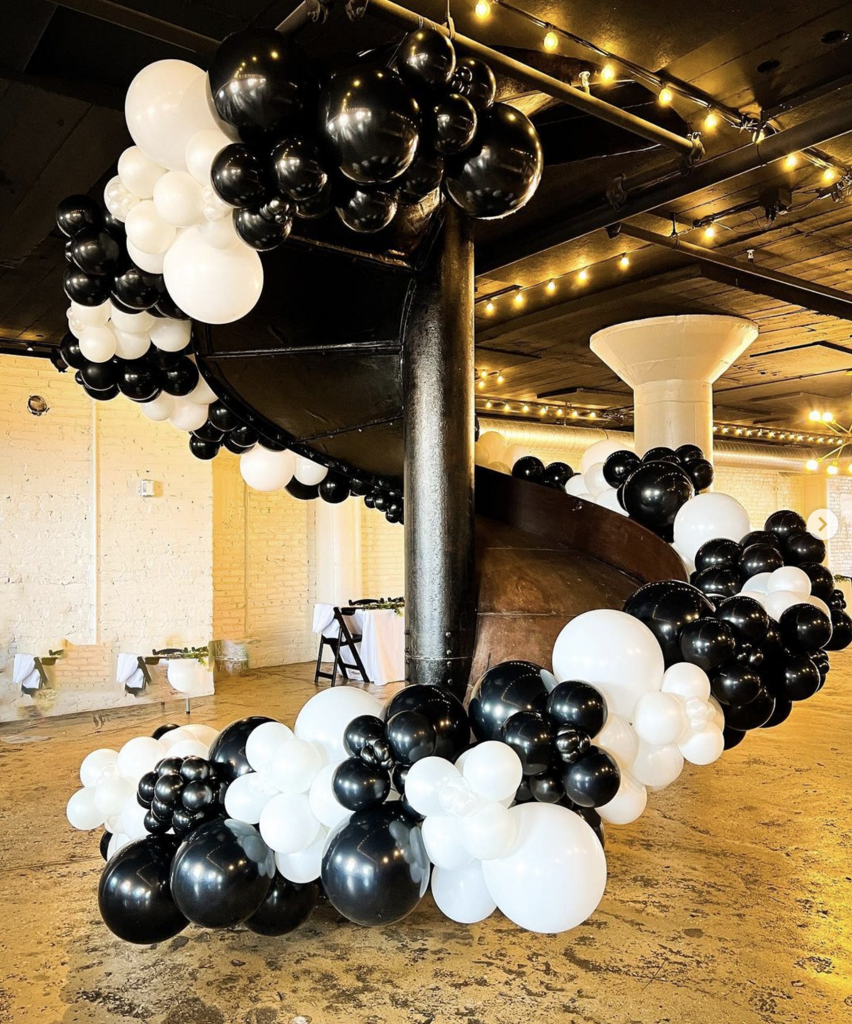 black and white balloon ceiling installation for upscale event decor.