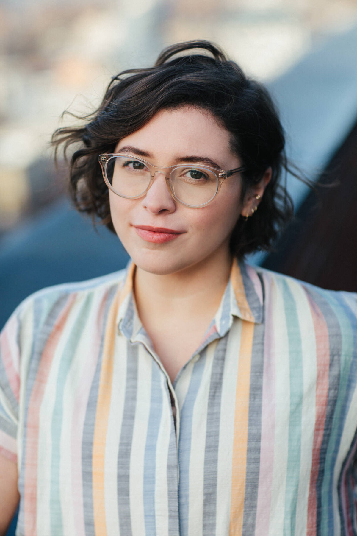 author portrait of casey mcquiston on a roofto